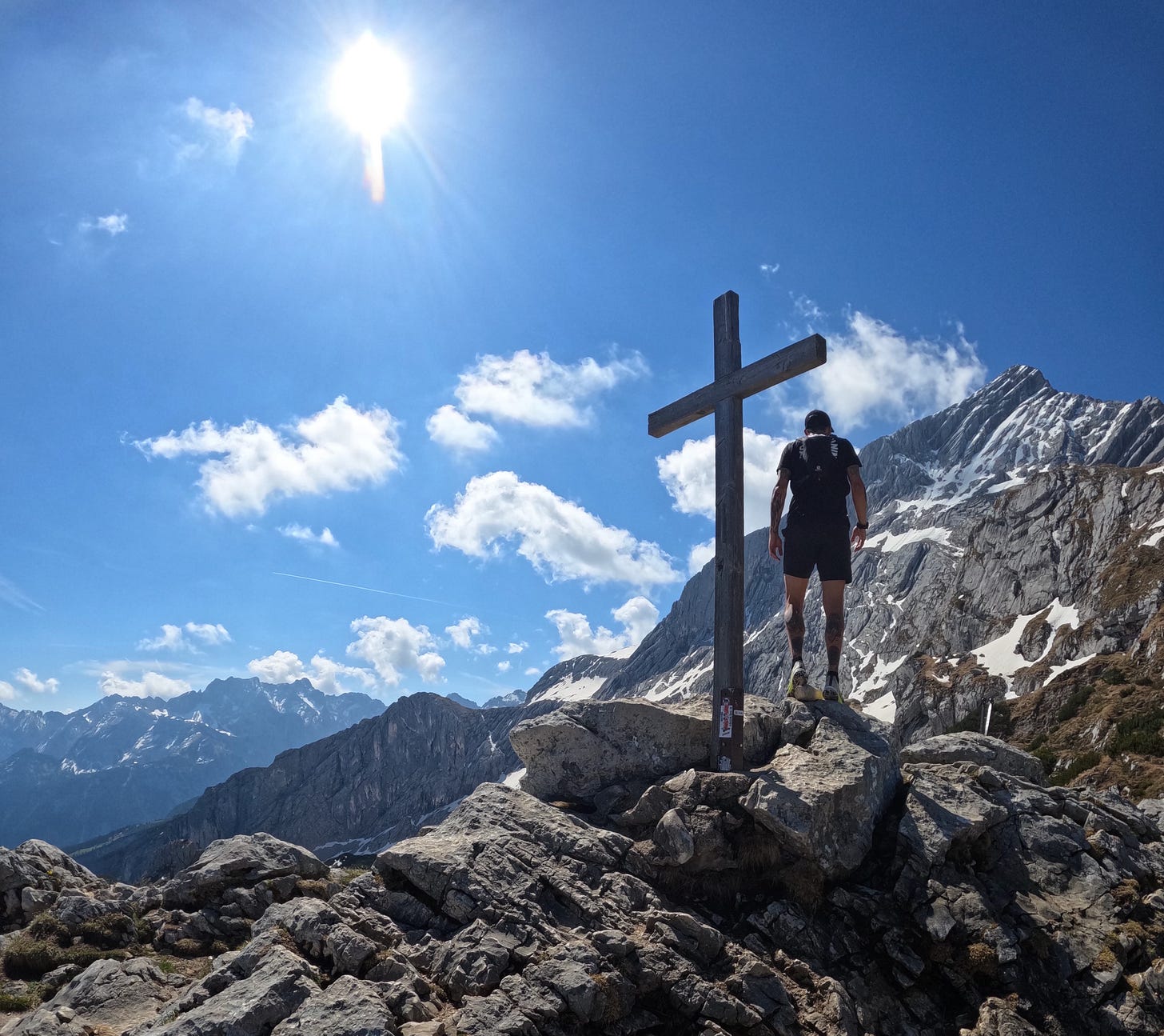 The author on top of a mountain looking at even more mountains