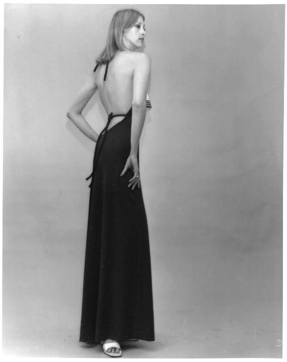 Full length body shot from Donna Blevins Model Portfolio, shot from the back where she’s wearing a backless evening gown