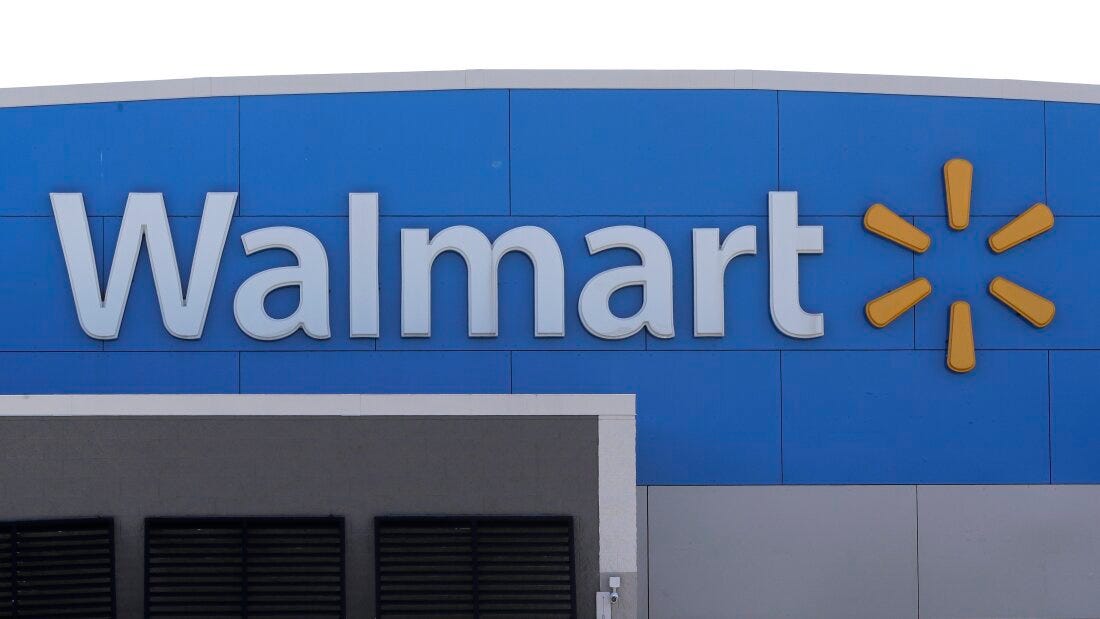 A Walmart logo is displayed outside of a Walmart store, in Walpole, Mass.