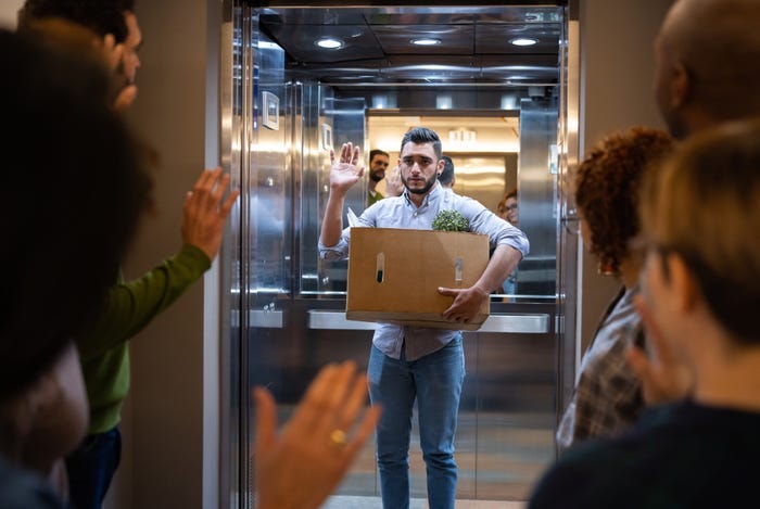 man getting laid off and waving goodbye