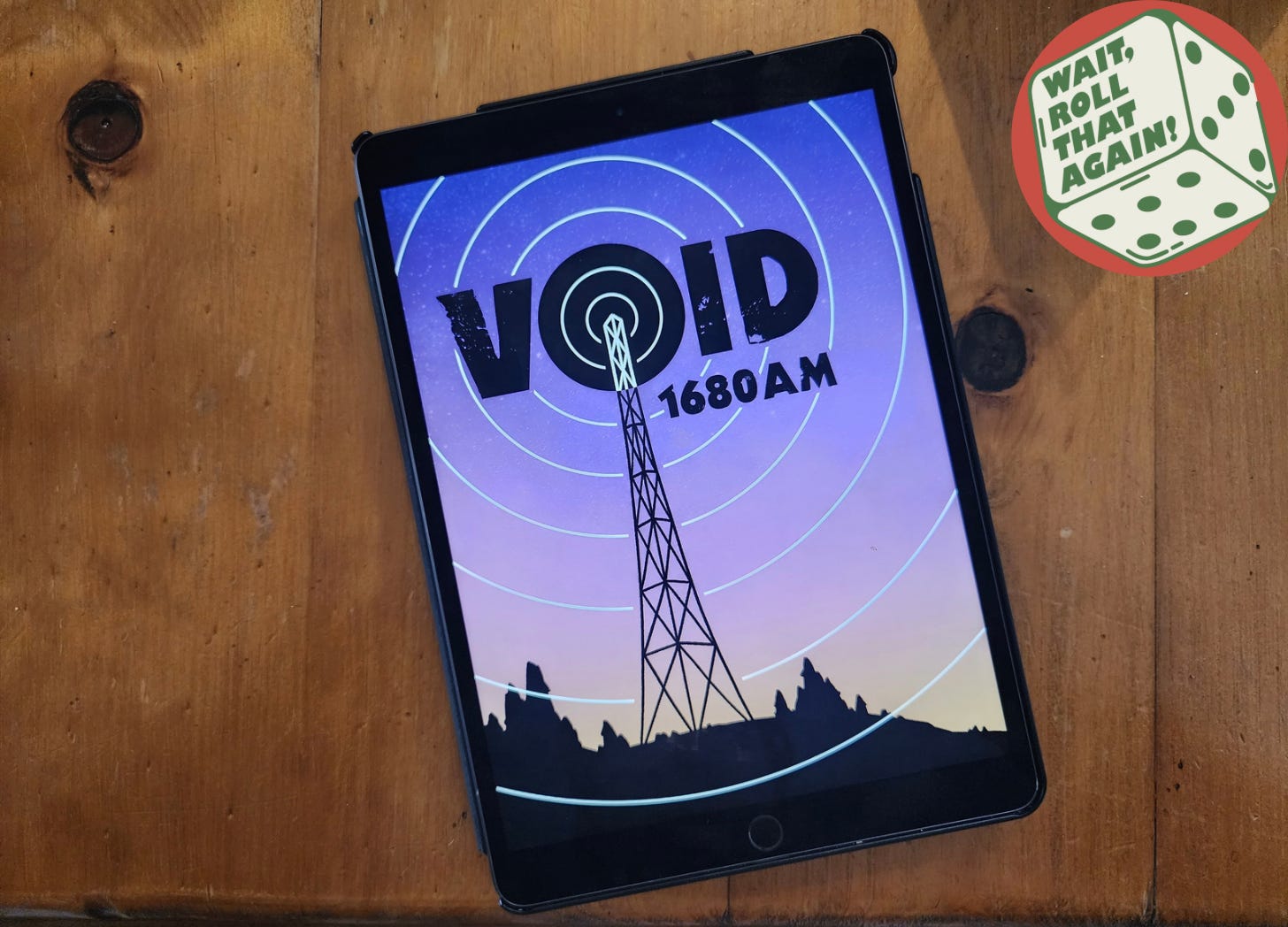 An iPad on a wooden table displays the cover of VOID 1680 AM, with a towering Radio Broadcast tower over a sunset background