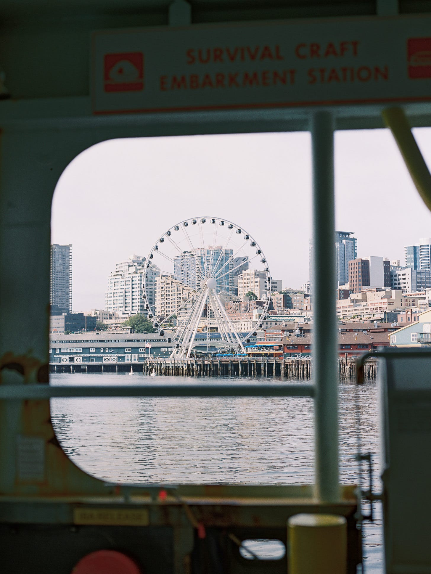 Photo of a ferris wheel, as seen from the window of a ferry