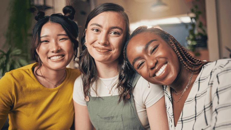 Smile, diversity and friends with portrait of women in living room for support, relax and happy.