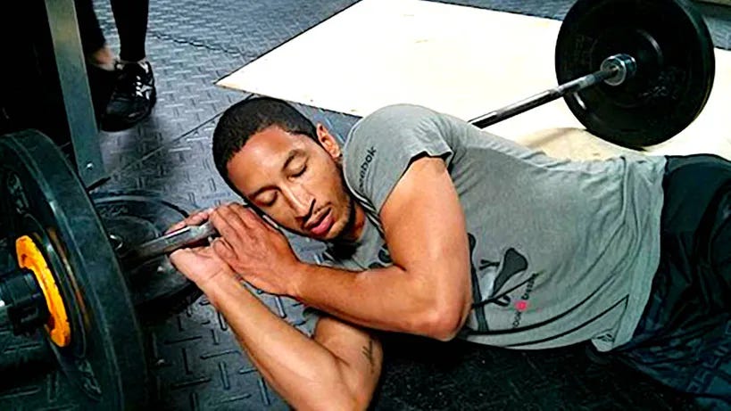 Man sleeping on the gym floor.