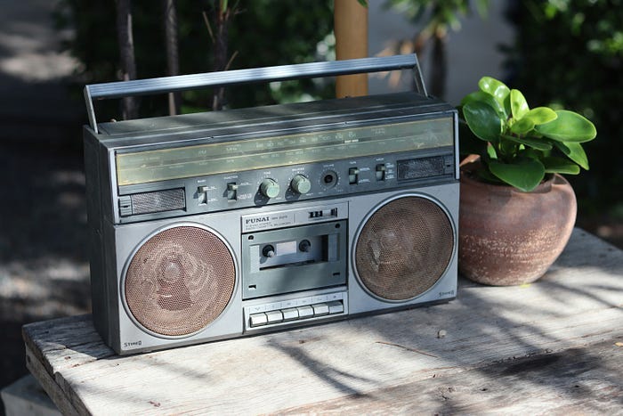 Radio playing music on a table.