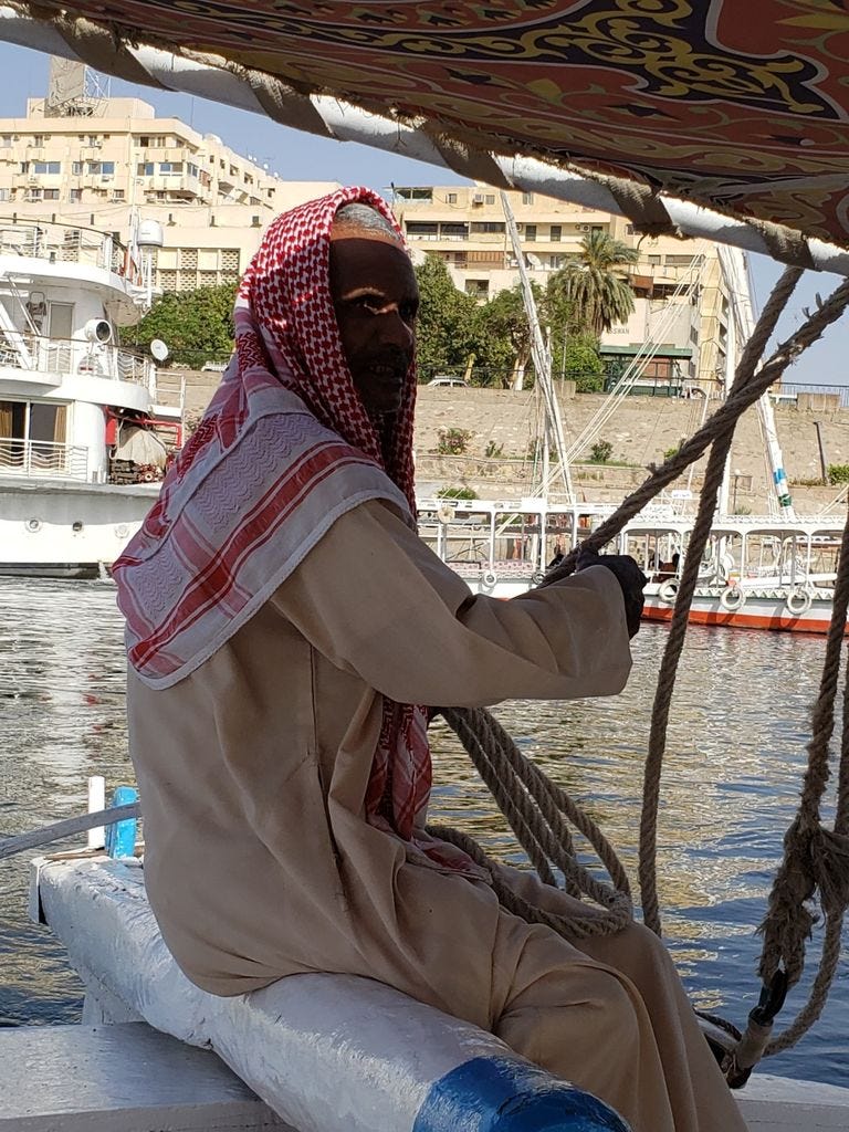 Fellucca Captain in Egypt steering the boat on the Nile