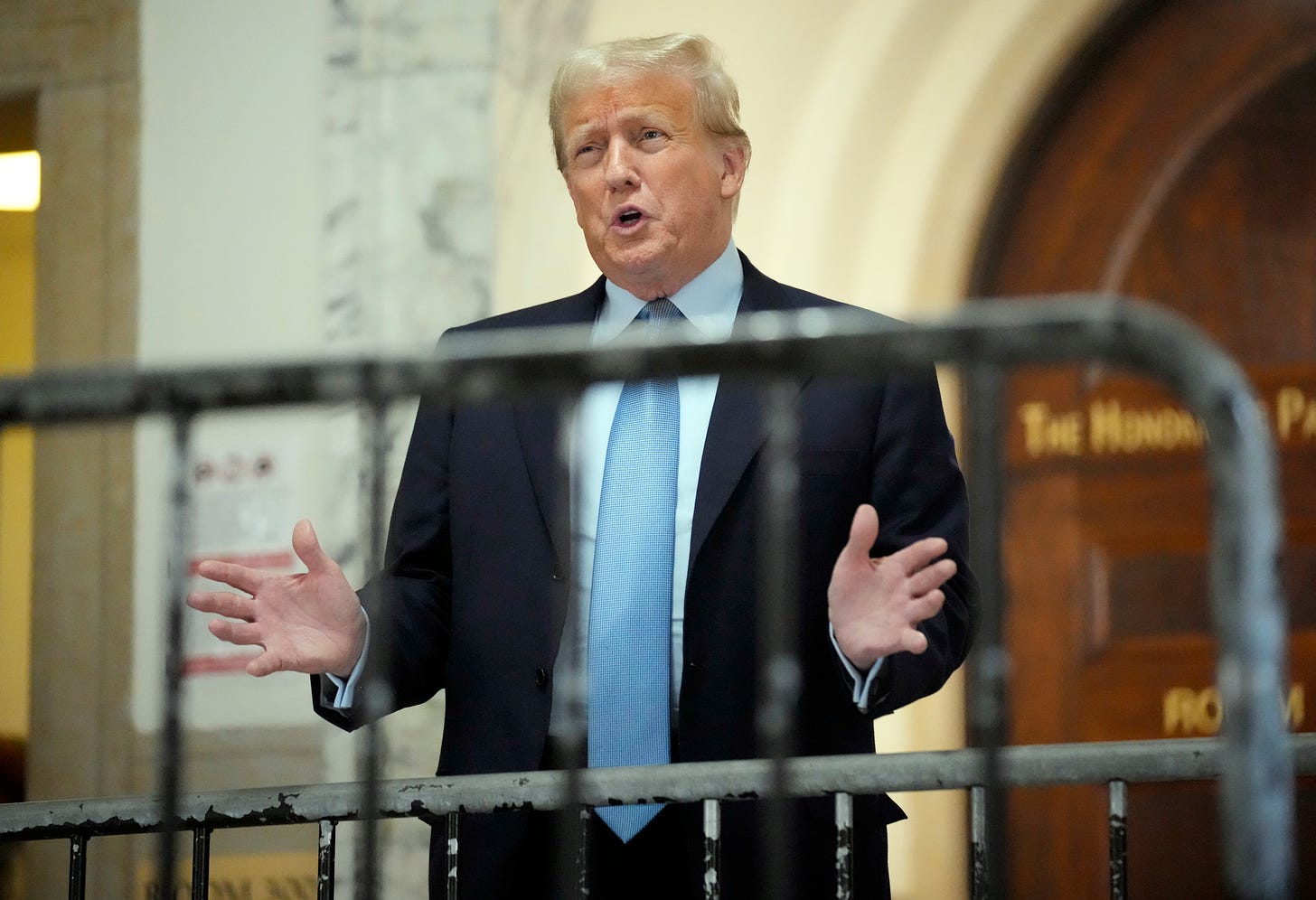 Former President Donald Trump speaks as he returns to the courtroom after the lunch break of his civil business fraud trial, Wednesday, Oct. 18, 2023, at New York Supreme Court in New York. 