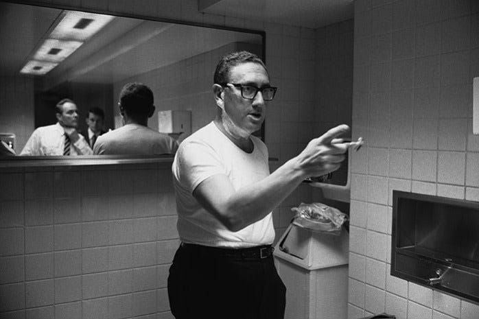 Henry Kissinger shaves in a bathroom in Washington