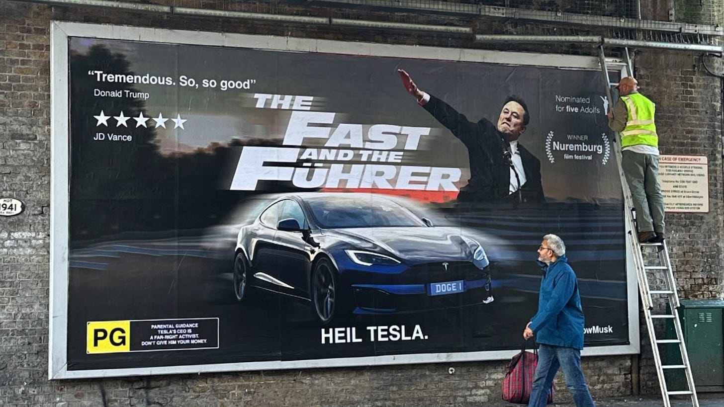 A billboard advertising a fake movie called The Fast and the Fuehrer showing a Tesla and Elon Musk doing a Nazi salute