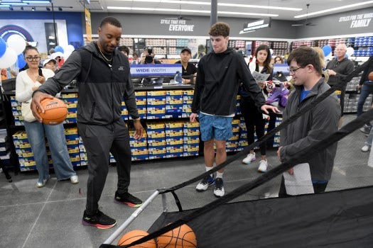 Jack Mondello, 18, and Owen Mooney,18, students with the Friendship Foundation, interview LA Clippers guard Norman Powell during Skecher’s grand opening of its new store in Torrance on Friday, June 6, 2025. (Photo by Axel Koester, Contributing Photographer)

