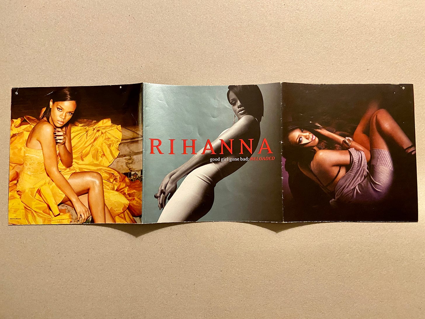 the images from Rihanna's album Good Girl Gone Bad; she wears a yellow dress in the first photo, a white dress in the album cover, and a purple dress in the third photo.