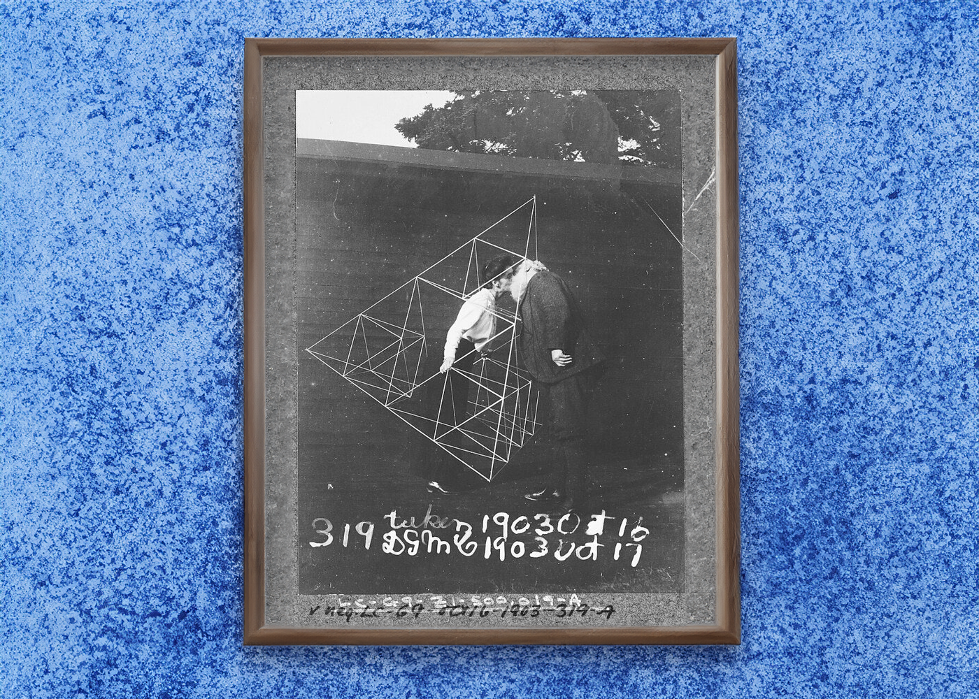 Alexander Graham Bell kissing his wife Mabel, within a tetrahedral kite, in 1903
