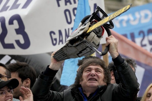 Presidential hopeful Javier Milei brandishes a chainsaw during a campaign event in La Plata, Argentina, Tuesday, Sept. 12, 2023.  (AP Photo/Natacha Pisarenko)Image of Argentine President Javier Milei holding a chainsaw during a public event, symbolizing his aggressive economic reforms.