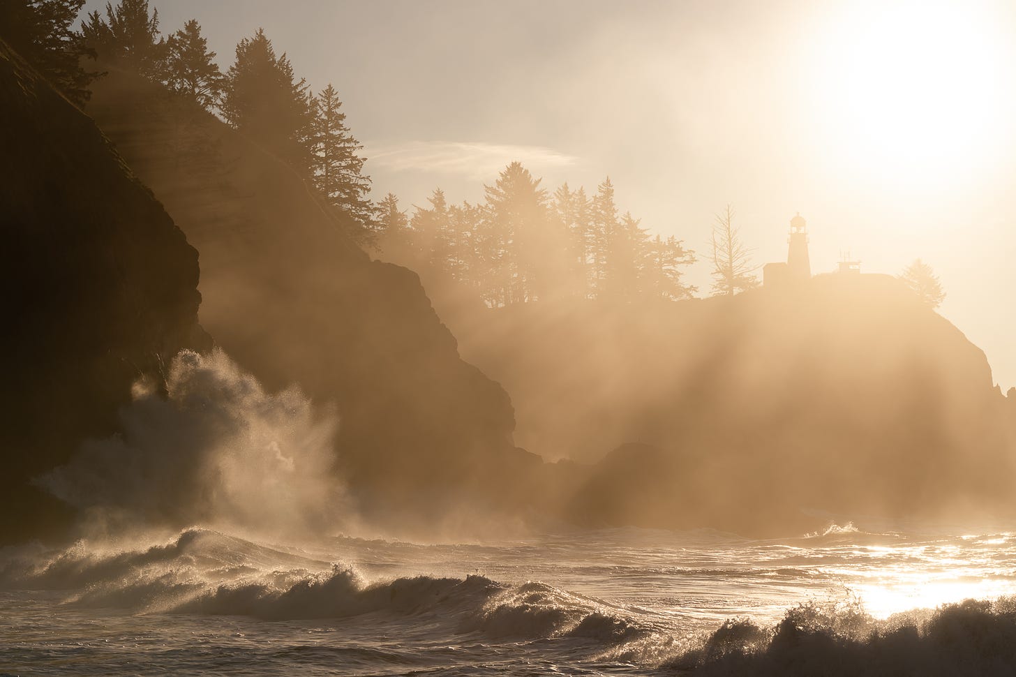 wave crashes against cliff at cape disappointment by jennifer carr photography