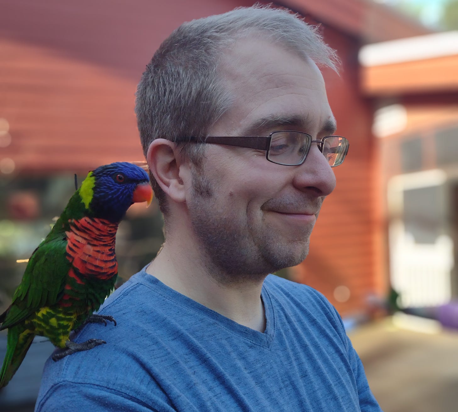 Me with a brightly colored bird on my shoulder.