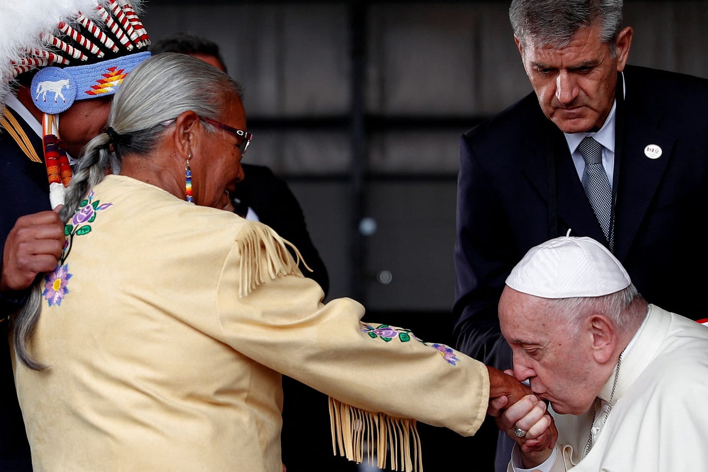 Pope Francis kisses the hand of Alma Desjarlais of Frog Lake First Nation during a welcome ceremony after arriving at Edmonton International Airport, near Edmonton, Alberta, Canada July 24, 2022. Pope Francis kisses the hand of Alma Desjarlais of Frog Lake First Nation during a welcome ceremony after arriving at Edmonton International Airport, near Edmonton, Alberta, Canada July 24, 2022.