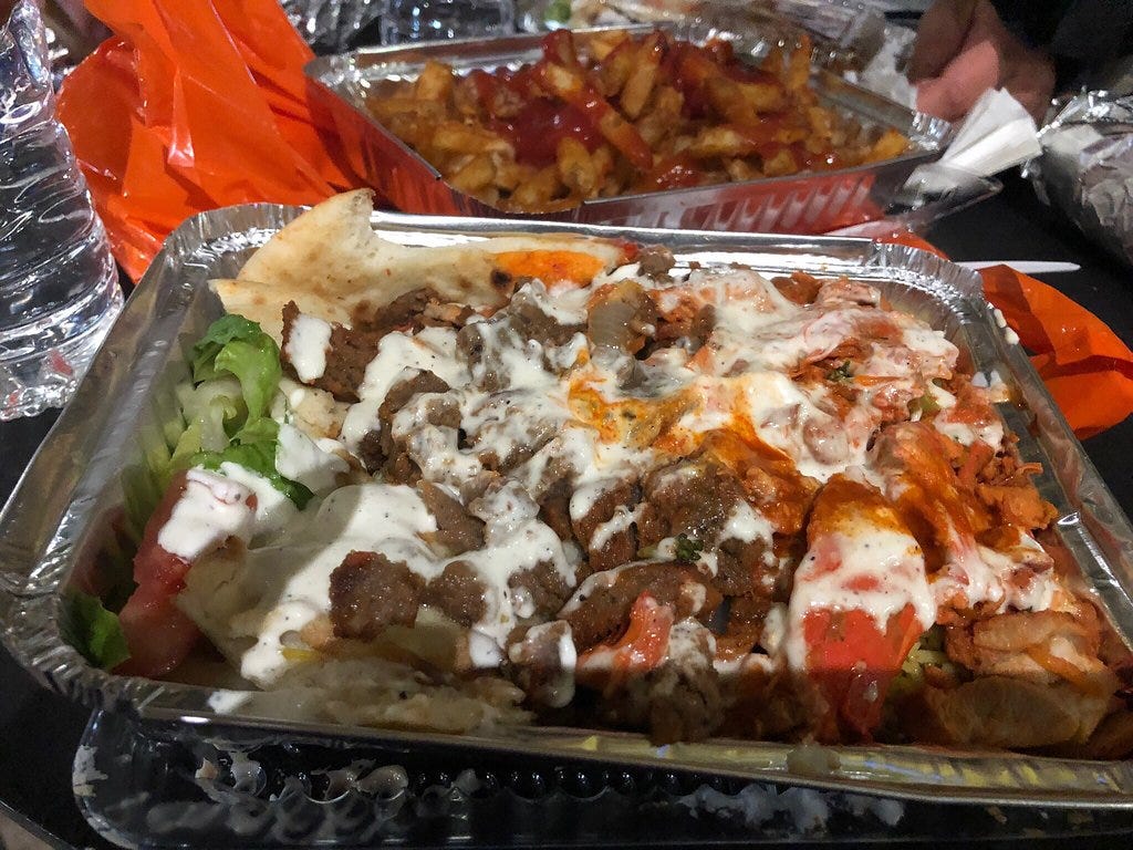 plate of halal food with white sauce and red sauce. photo from TripAdvisor