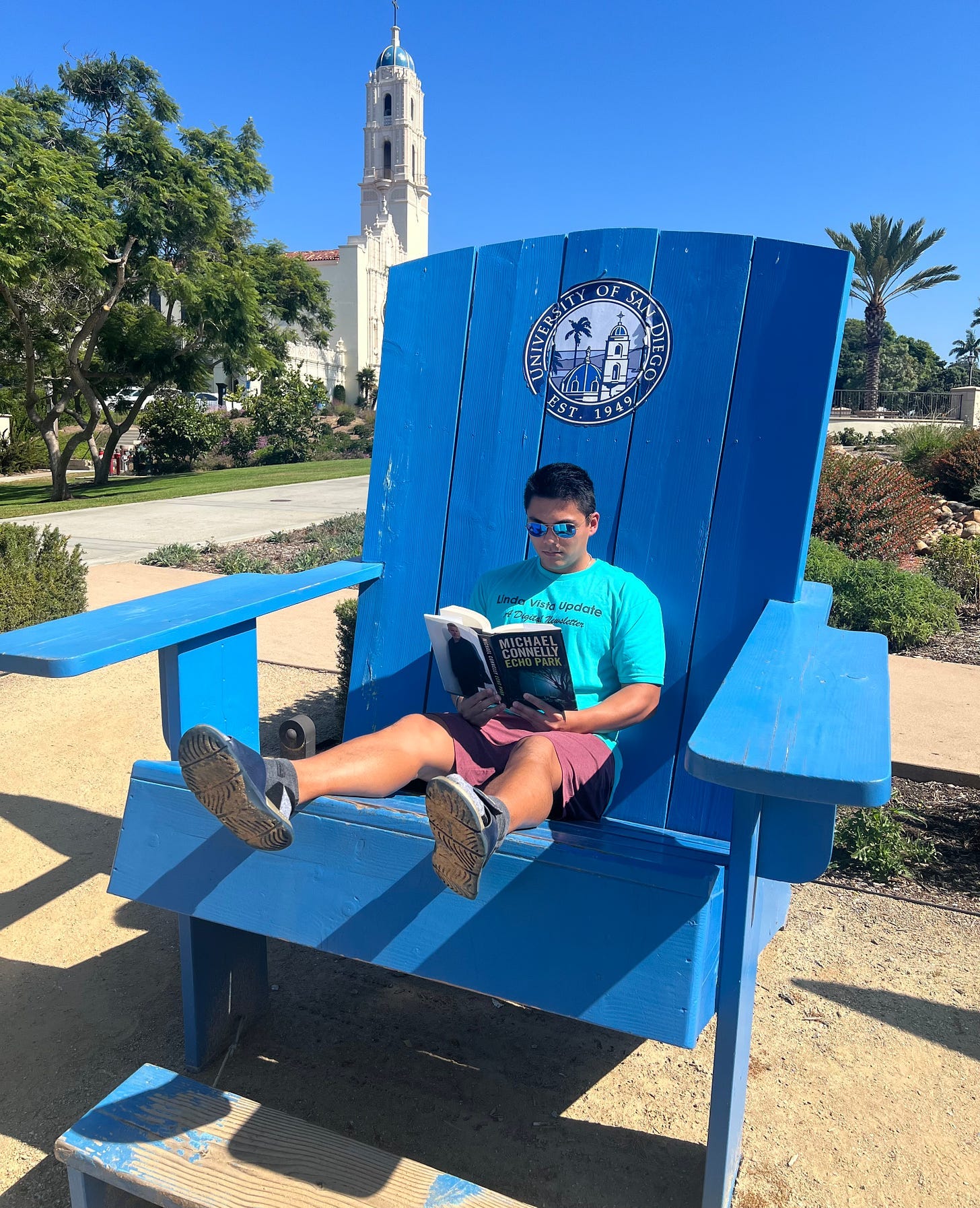 A person sitting in a large blue chair

Description automatically generated