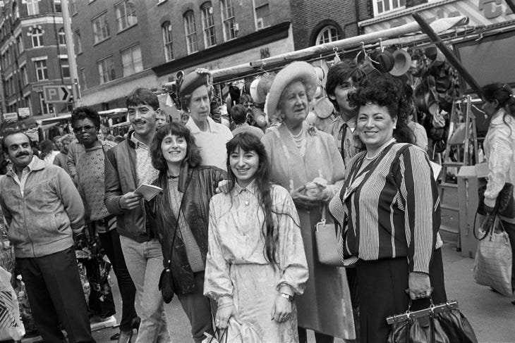 Black and white photos of people posing with cut outs of the Queen and Queen Mother