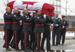 A Toronto Police ceremonial guard outside the Toronto Congress Centre carry the casket of Toronto Police Constable John Zivcic,, who died in the line of duty while responding to an impaired driver call.