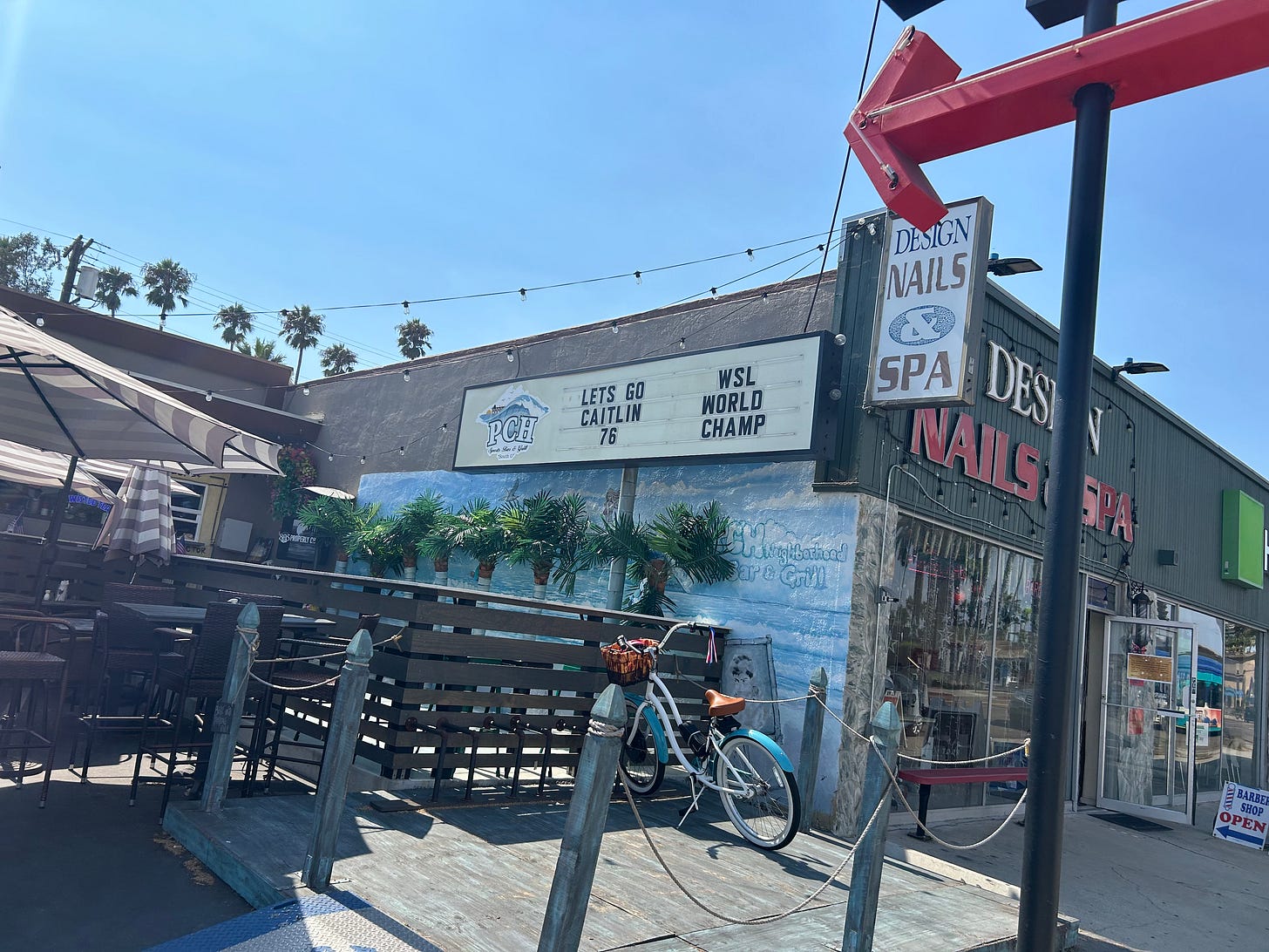 A sign at PCH Sports Bar in Oceanside, California that reads “Let’s Go Caitlin 76 WSL World Champ”. Photo credit: My wife