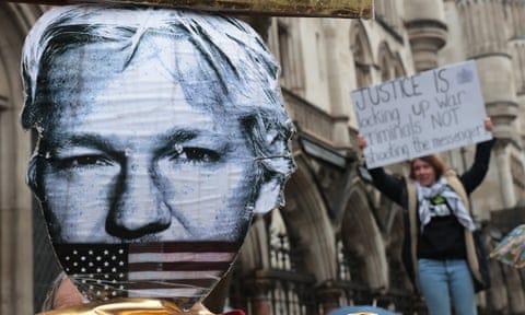 A black-and-white print-out image of a white man, with the American flag superimposed over his mouth, and a woman blurred in the background holding a protest sign.