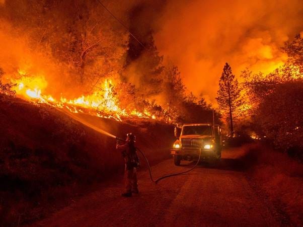 A firefighter spraying water on a fire

AI-generated content may be incorrect.