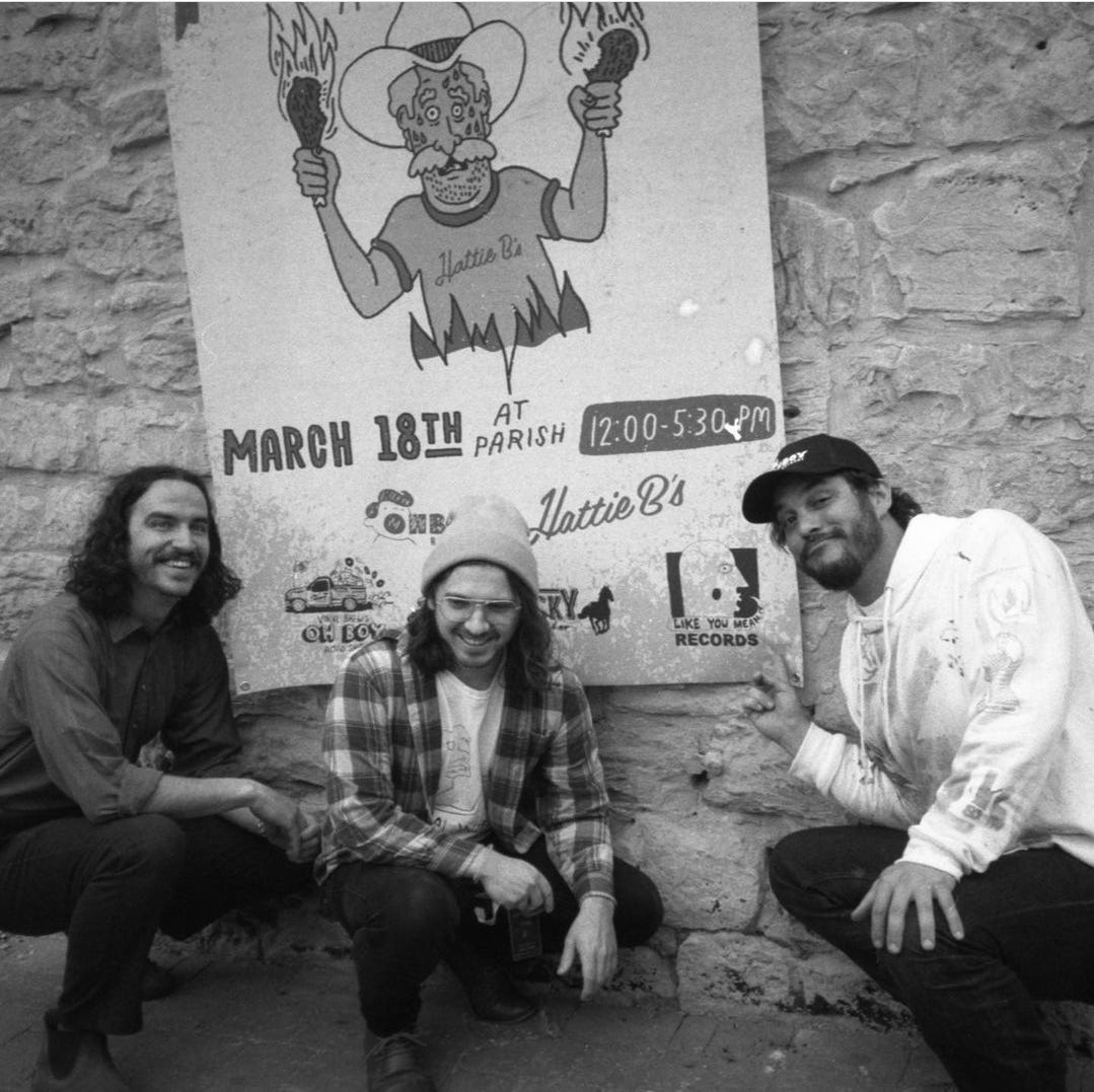 Gusti, myself, and Collin in front of the poster hung up outside the venue
