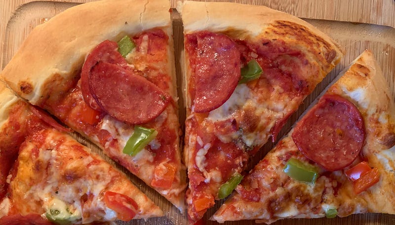 4 slices, half of a pizza I recently made with pepperoni, green peppers, tomato sauce and cheese. Crust is a nice golden brown.