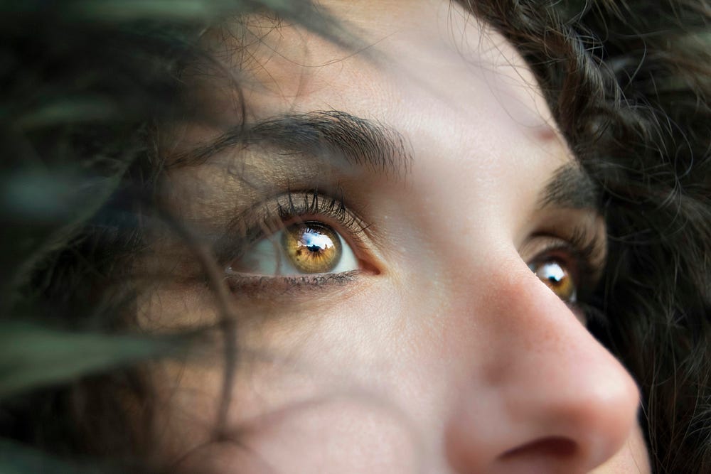 Woman with brown eyes looking at ahead.