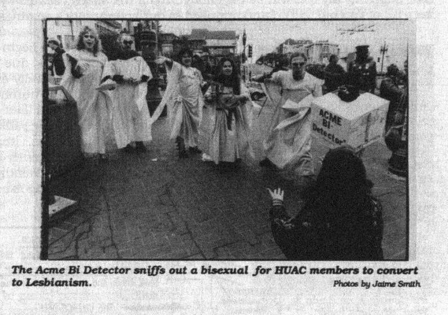 A group of people in robes alongside a person in a box that reads "ACME Bi Detector." The caption reads "The Acme Bi Detector sniffs out a bisexual for HUAC members to convert to Lesbianism."