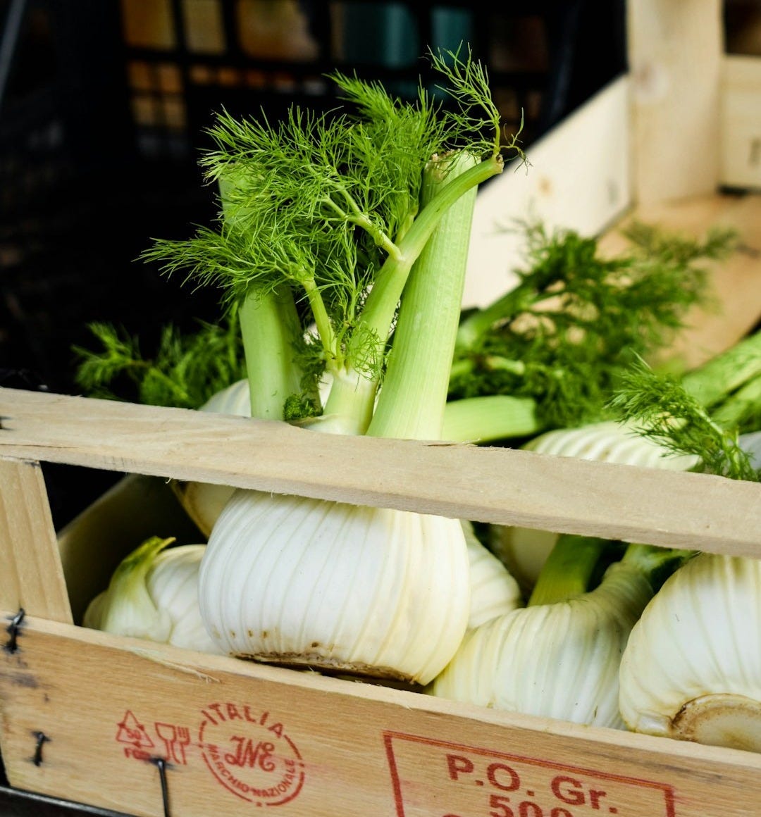 a crate filled with lots of green vegetables a crate filled with lots of green vegetables