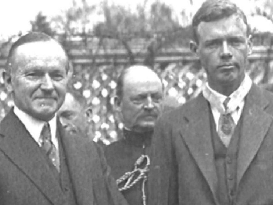 Black and white photo showing Coolidge with Lindbergh.  The Medal hangs around Lindbergh's neck.