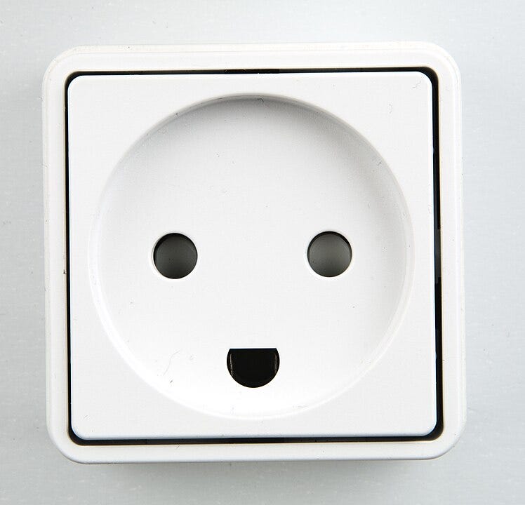 A photograph close-up of a Danish electrical outlet.