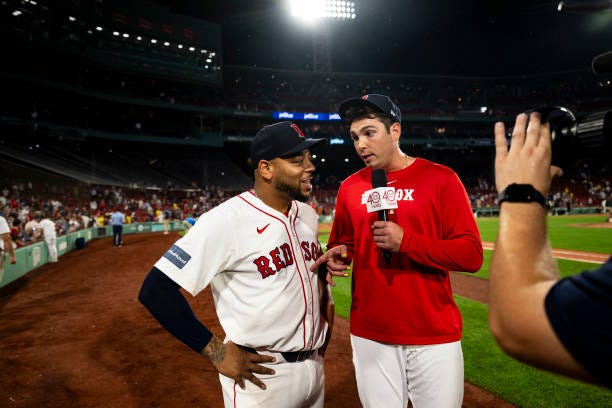 Triston Casas of the Boston Red Sox conducts a post-game interview on NESN with Dominic Smith after a victory against the Oakland Athletics on July...