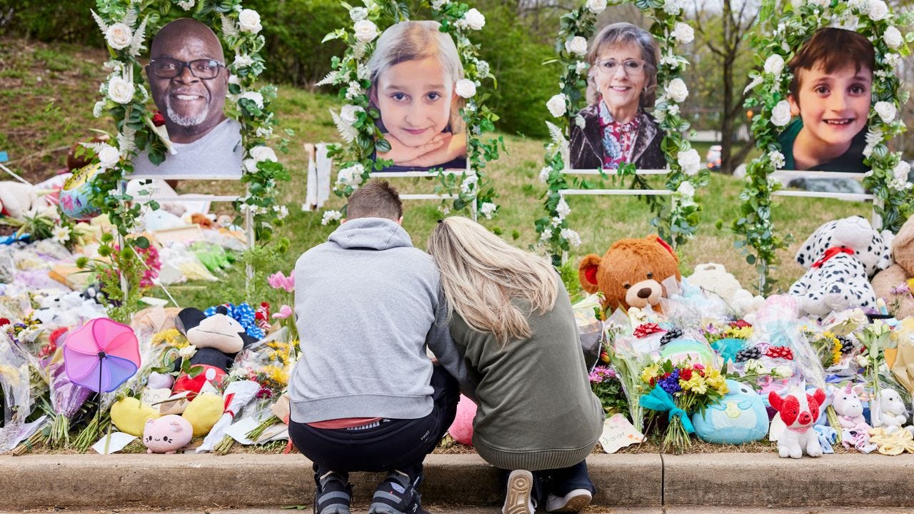 A couple prays at the memorial for the victims of the shooting at the Covenant School in Nashville.