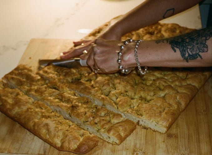 Chloe slicing focaccia