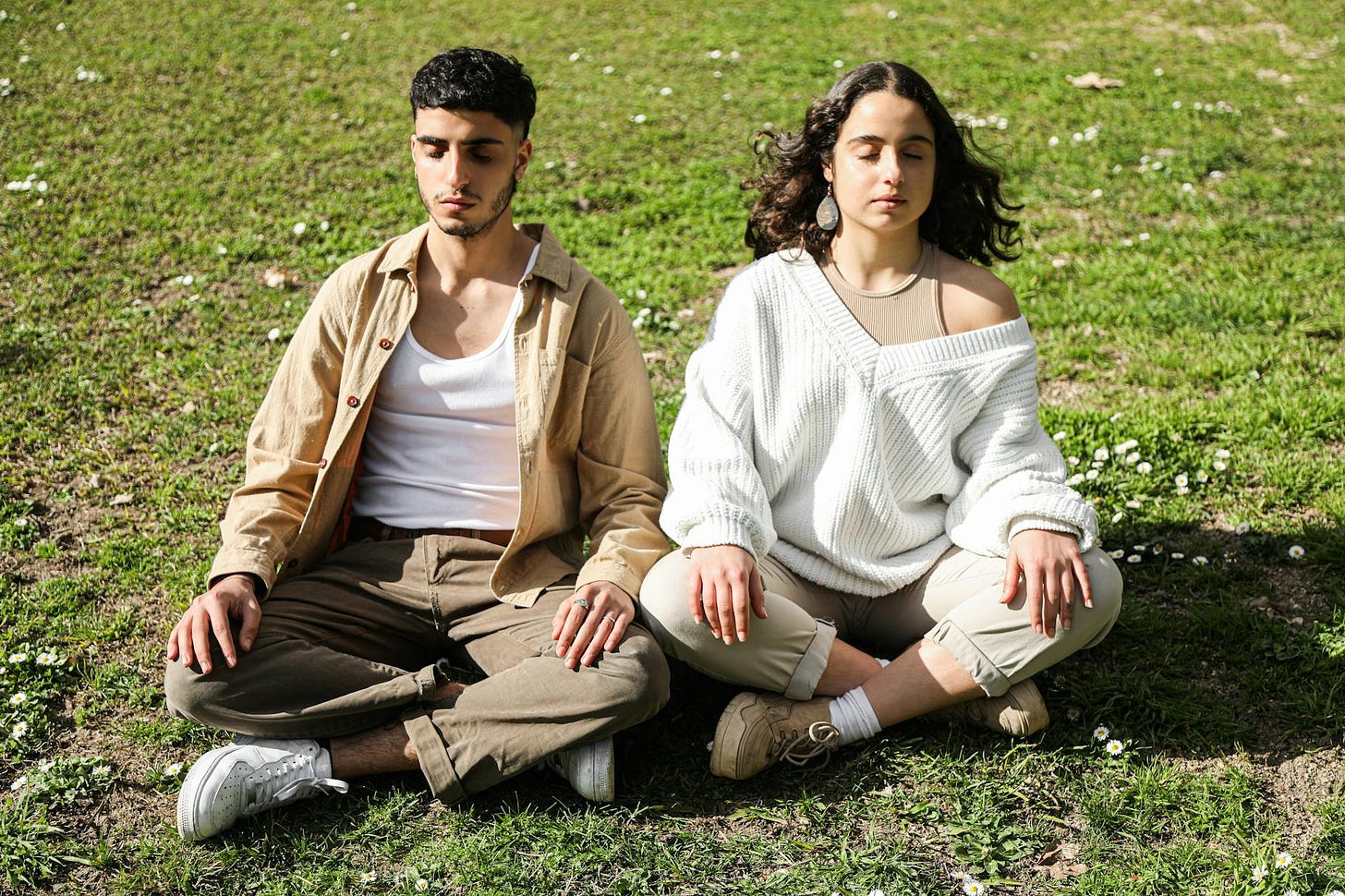 https://www.pexels.com/photo/a-man-and-woman-sitting-on-a-grassland-6962536/