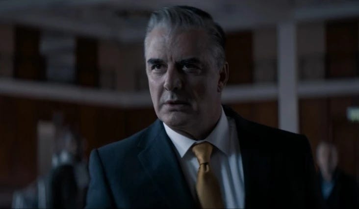 This image from "Arachnids in the UK" (Doctor Who Series 11's fourth episode) shows American hotelier (and blowhard) Jack Robertson (played by Chris Noth) as he scowls at the offscreen Doctor. Robertson stands in the large ballroom of his Sheffield hotel. This image from "Arachnids in the UK" (Doctor Who Series 11's fourth episode) shows American hotelier (and blowhard) Jack Robertson (played by Chris Noth) as he scowls at the offscreen Doctor. Robertson stands in the large ballroom of his Sheffield hotel.
