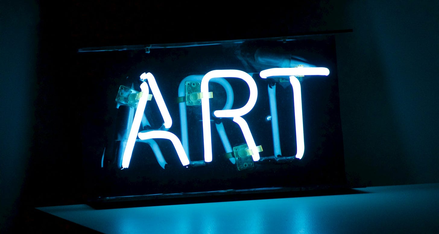 the word ART in neon lights, blue on a black background