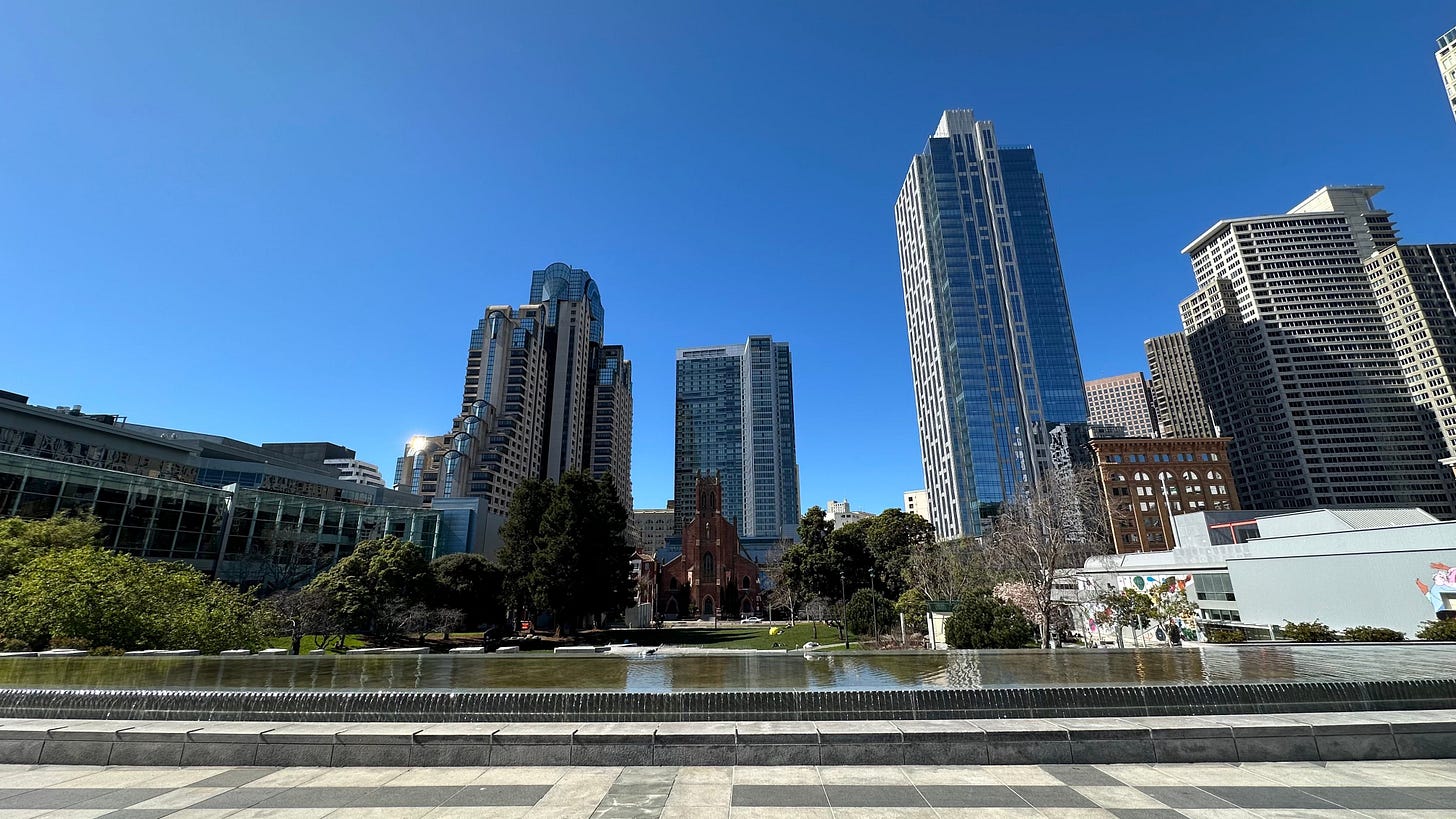 San Francisco skyline viewed from the 1st floor at Yerba Buena Gardens during a sunny day.