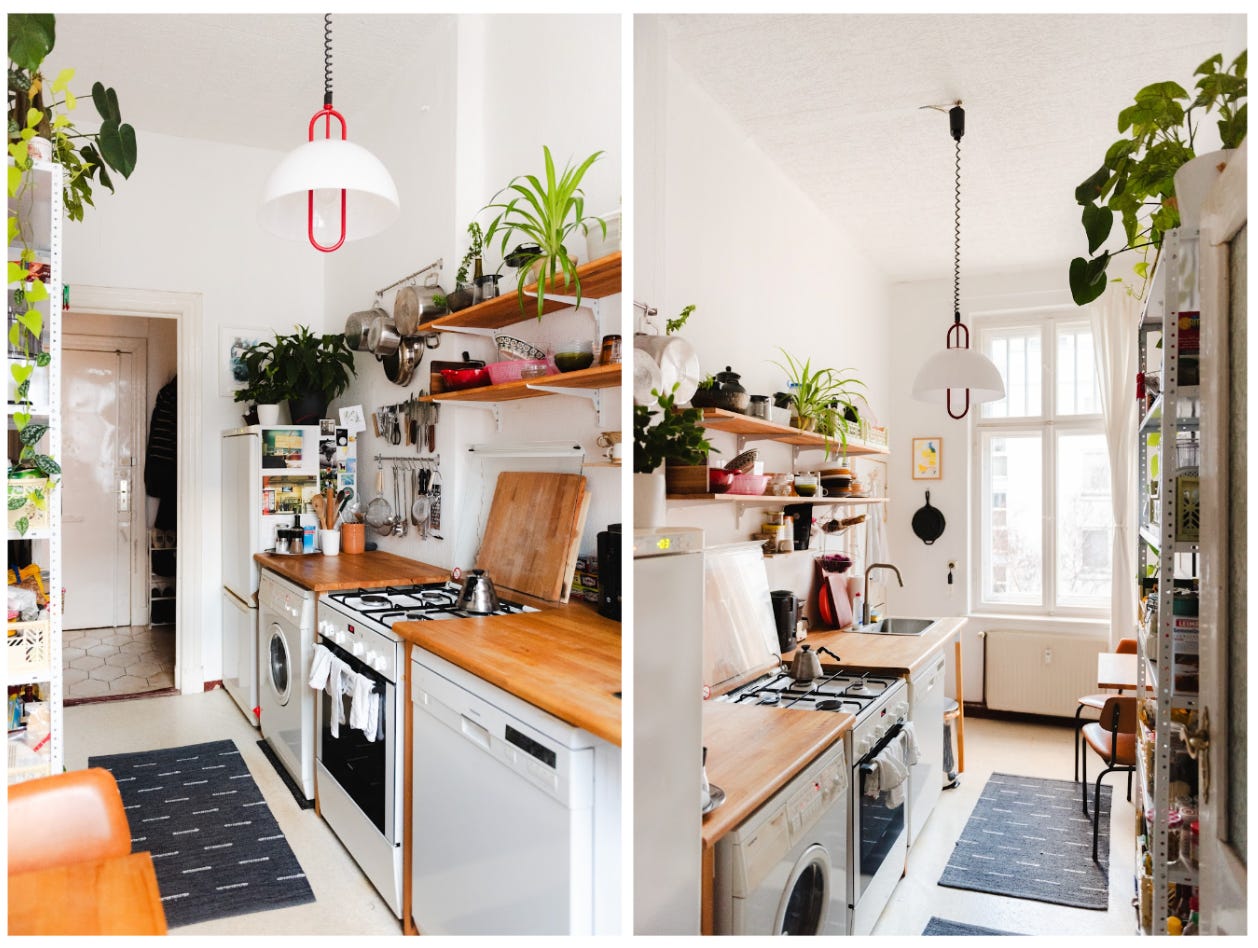 Kitchen with white walls, and open wooden shelves.