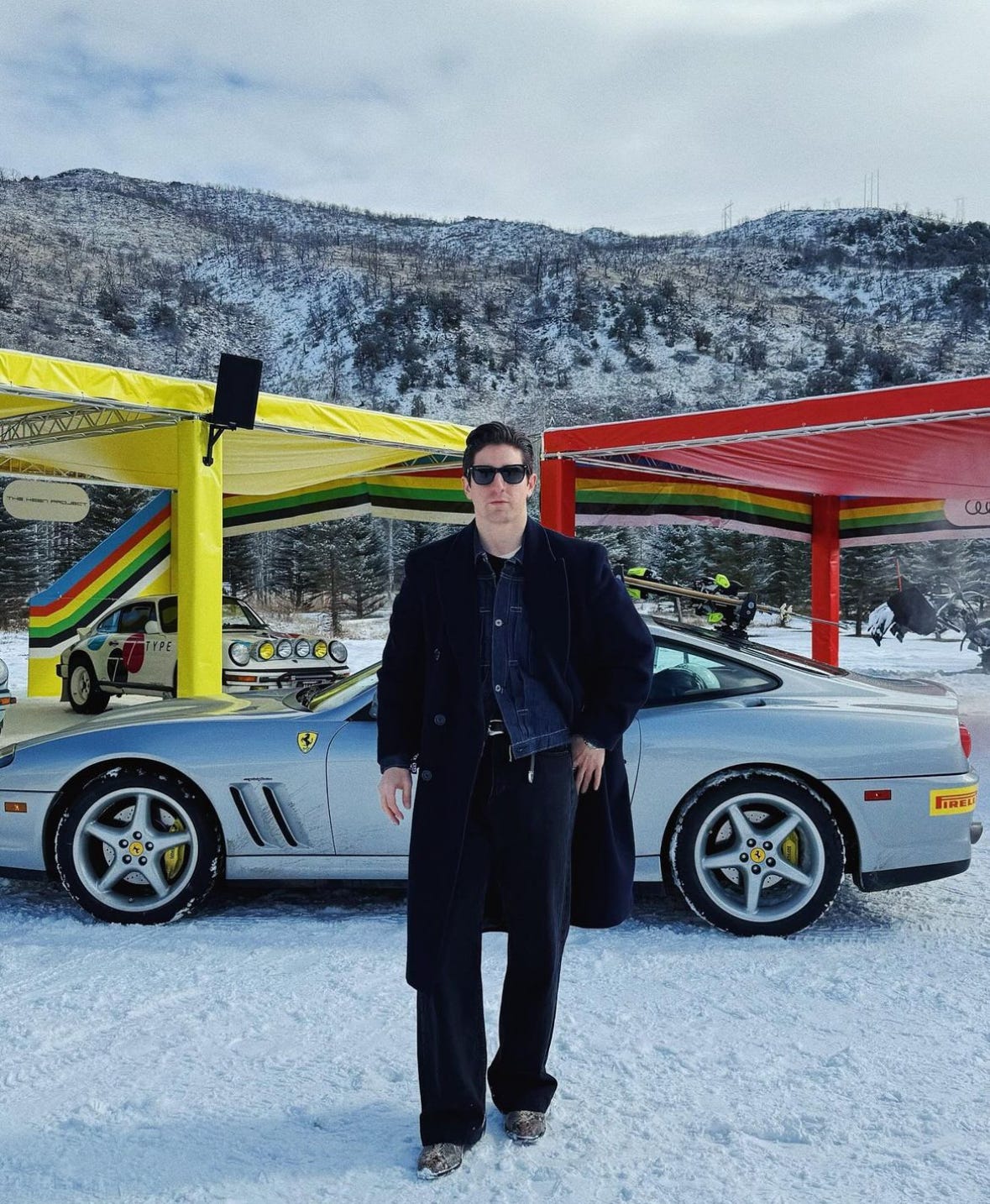 Jake Woolf standing in front of a Ferrari.