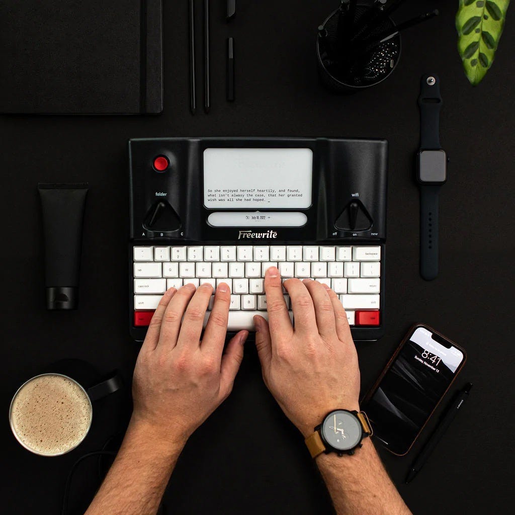 Picture of a Freewrite Smart Typewriter, with someone’s hands on the keyboard.