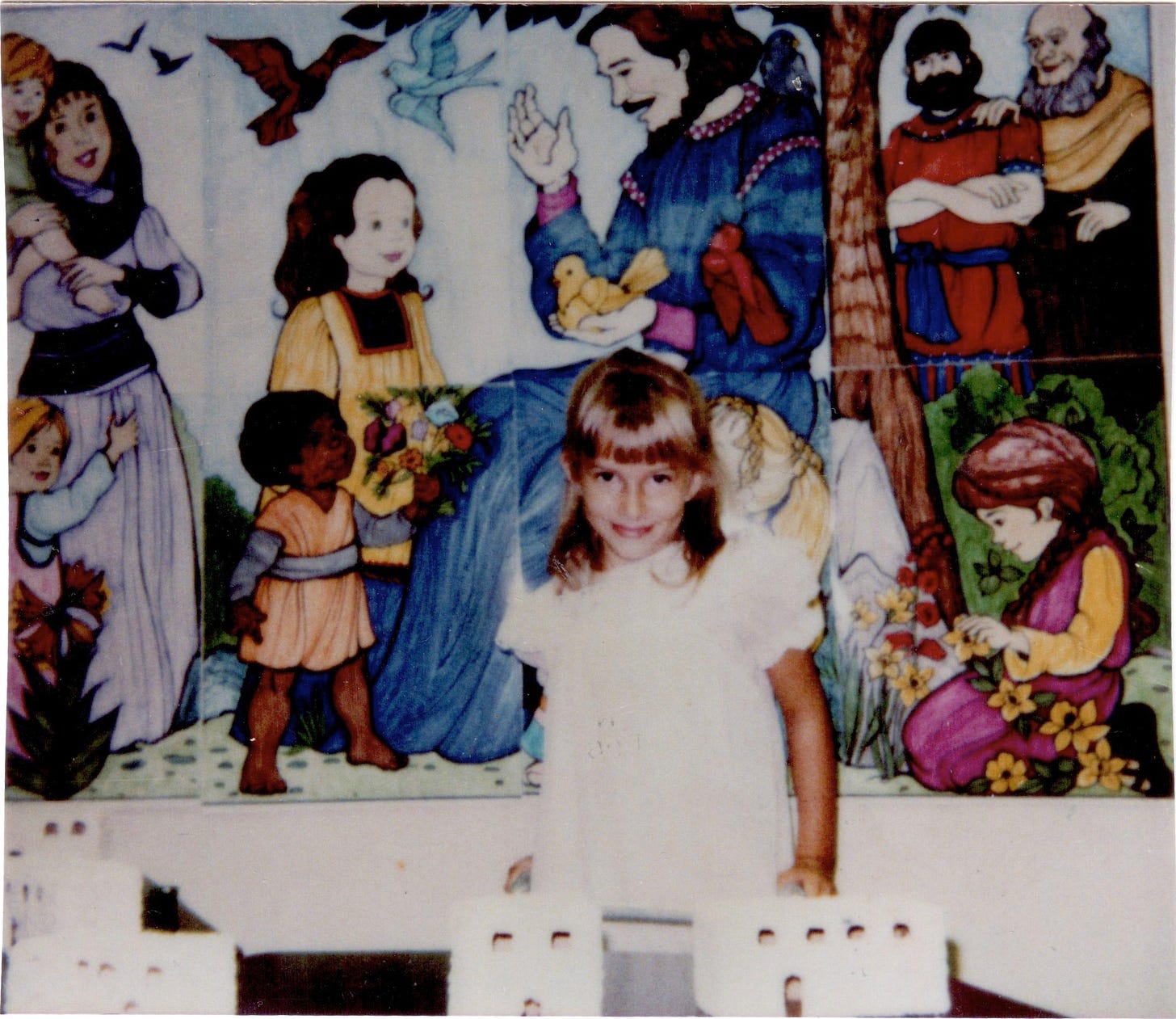 Rebekah stands in front of a mural in a ruffled dress, smiling at the camera with a closed moth, chin down. You can just make out that she's standing with a walker. Rebekah stands in front of a mural in a ruffled dress, smiling at the camera with a closed moth, chin down. You can just make out that she's standing with a walker.