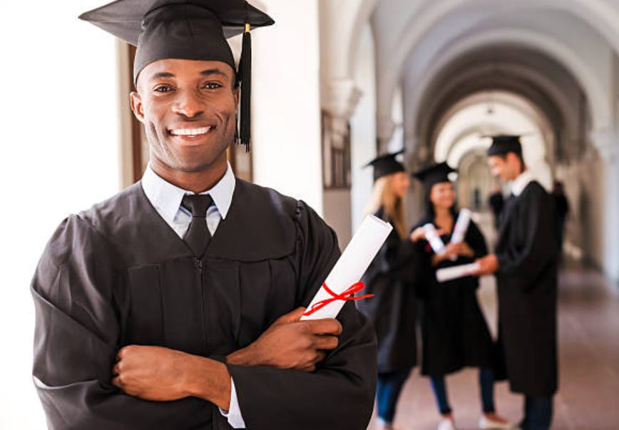 Black college graduate with arms folded