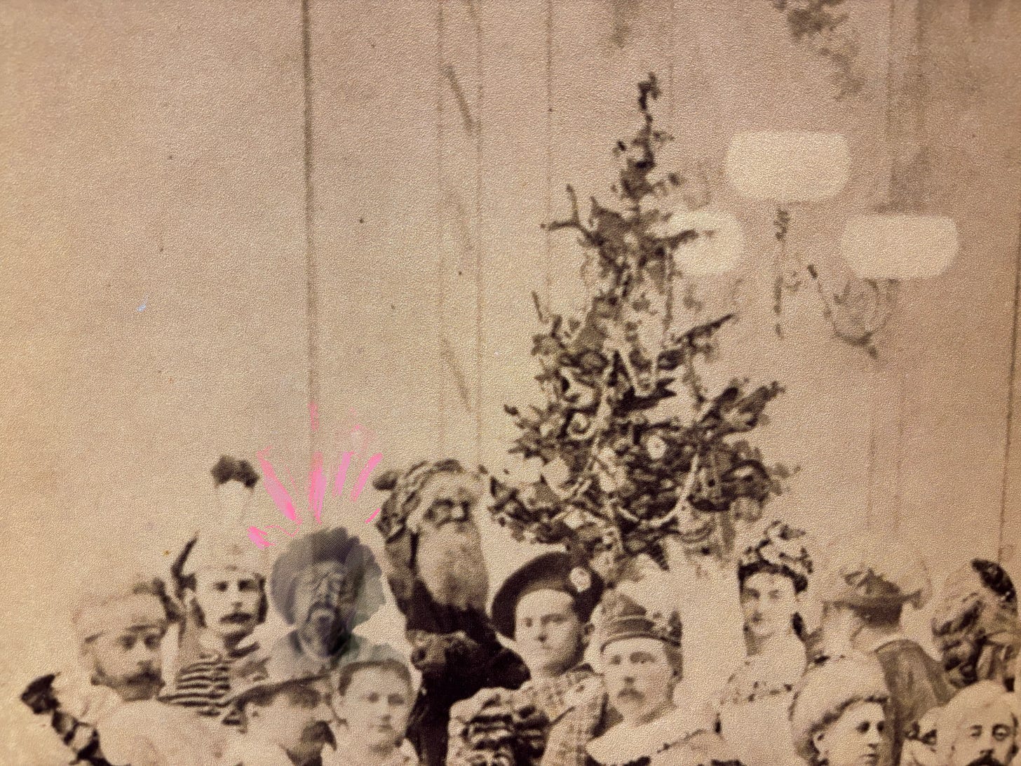 photo collage of a dozen people surrounding a Christmas tree with Santa and Andrew in costume