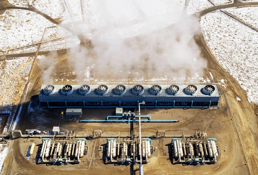 Aerial photo of a geothermal plant in the snowy Nevada desert, with steam coming from its generators 