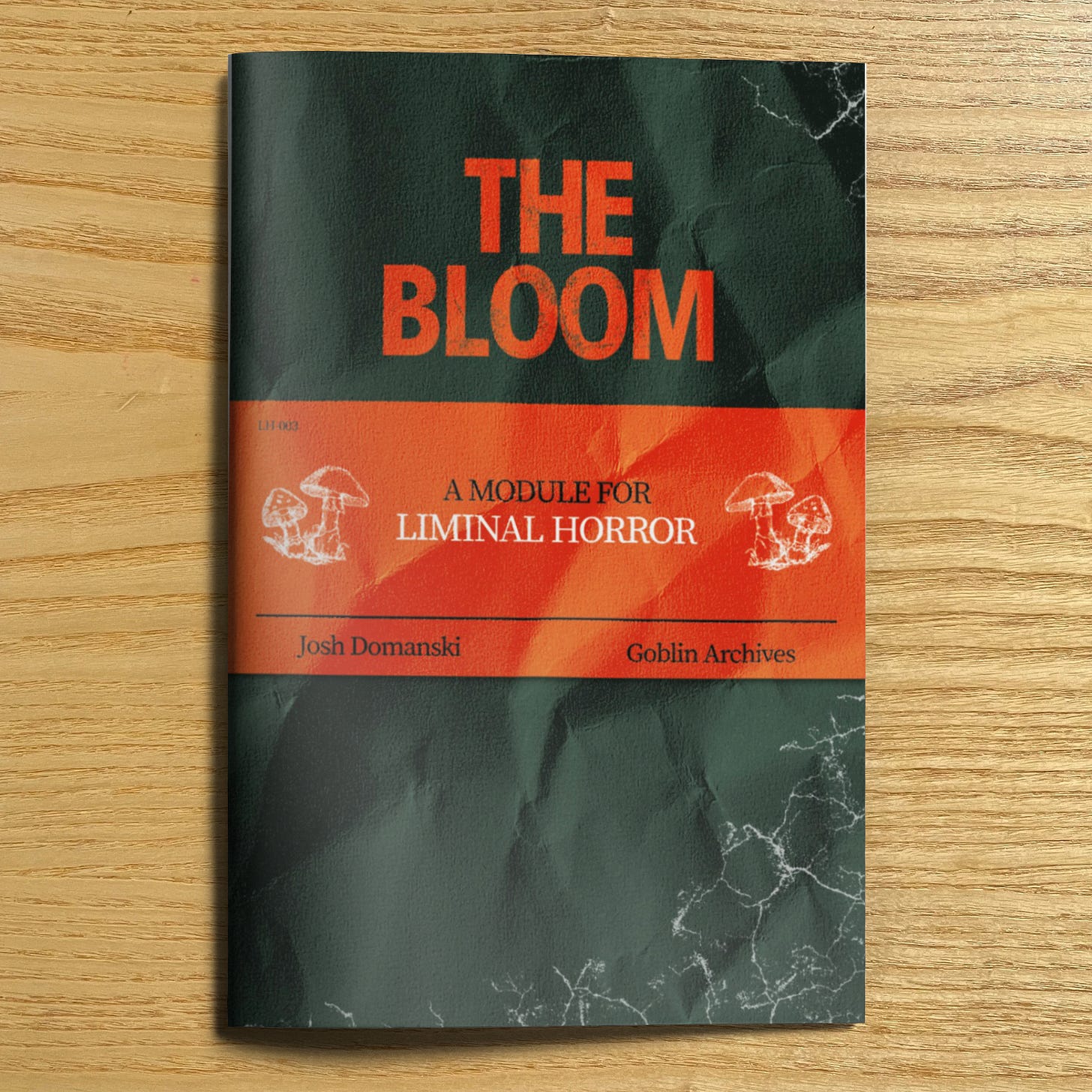 A physical copy of the Bloom by Josh Domanski and Goblin Archives. The cover is black, red, and white, and features illustrations of mushrooms.