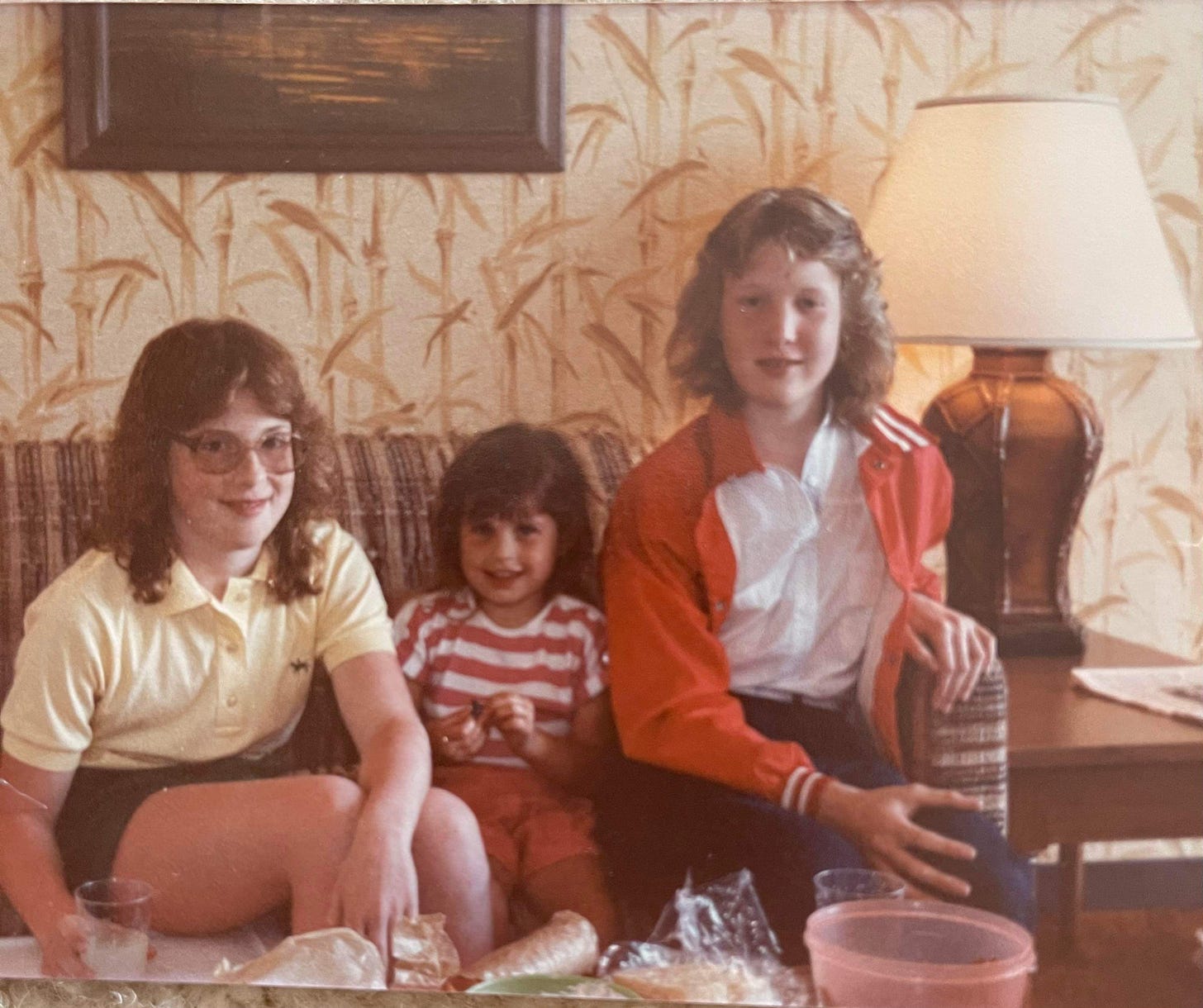 A circa 1980s photo of three girls sitting on a sofa in a Florida condominium